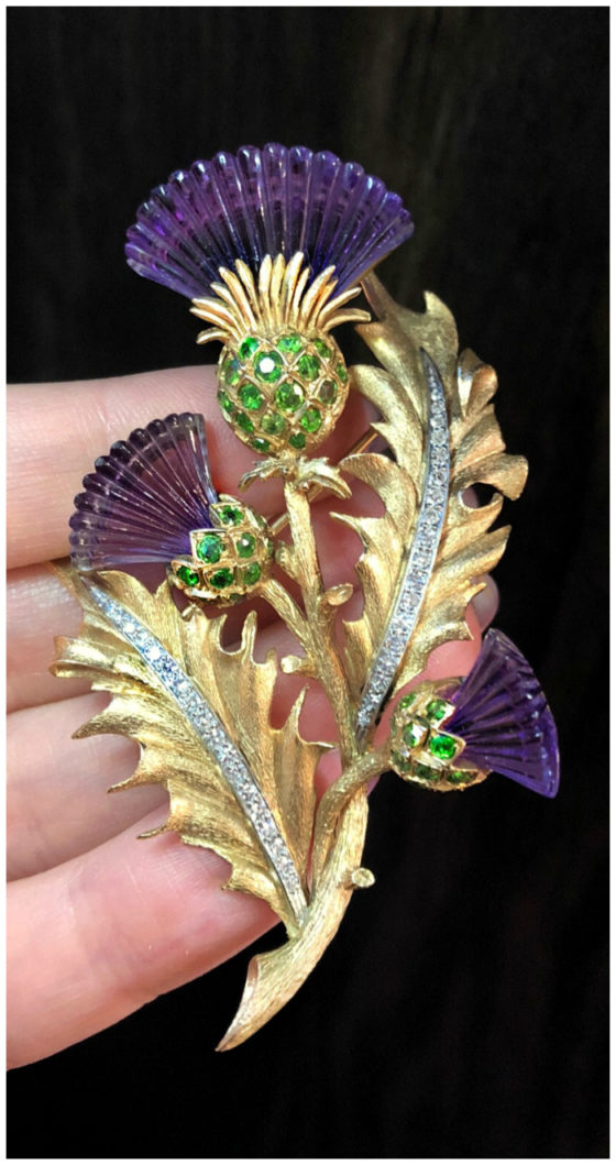 A stunning vintage thistle brooch from Wilson's Estate Jewelry. Carved amethyst, demantoid garnets, and diamonds in gold.