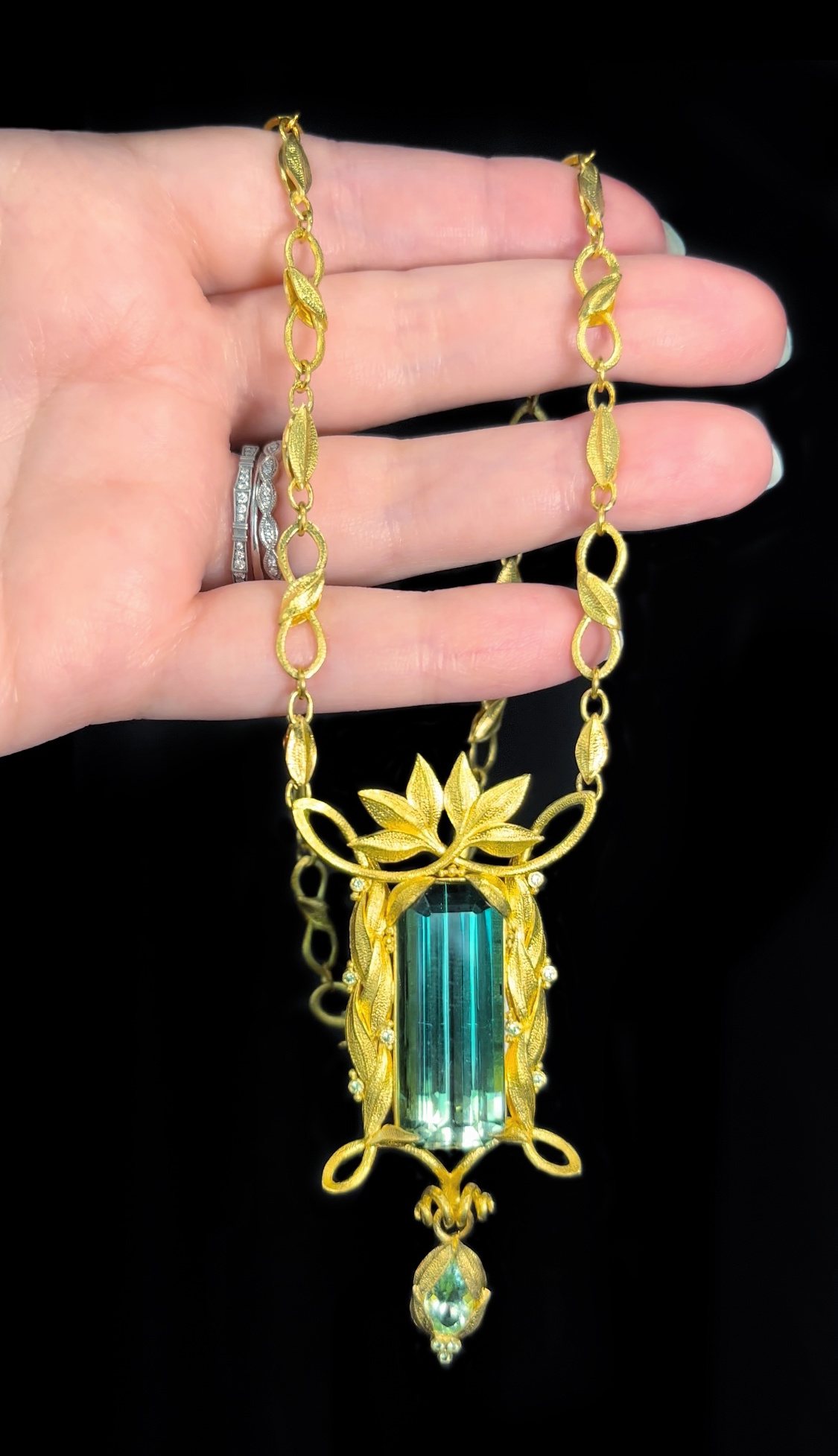 22K yellow gold Gary Roe Jewelry necklace featuring a 33 ct. bicolor Tourmaline, pear-shape Tourmaline, and Tsavorite Garnets.