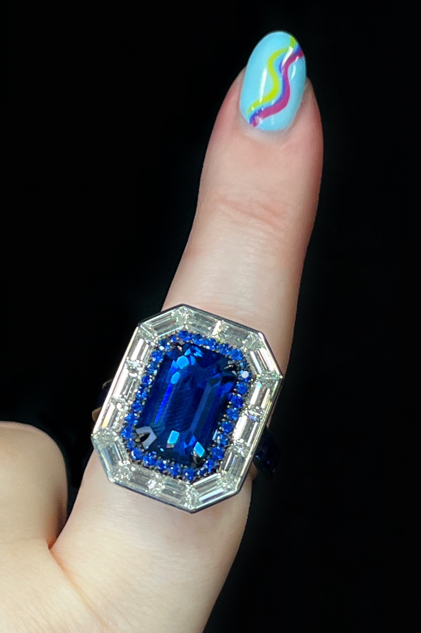 Sapphire engagement ring by Pompos Jewelry, featuring a 6.29 ct. blue Ceylon Sapphire accented with sapphires and diamonds.