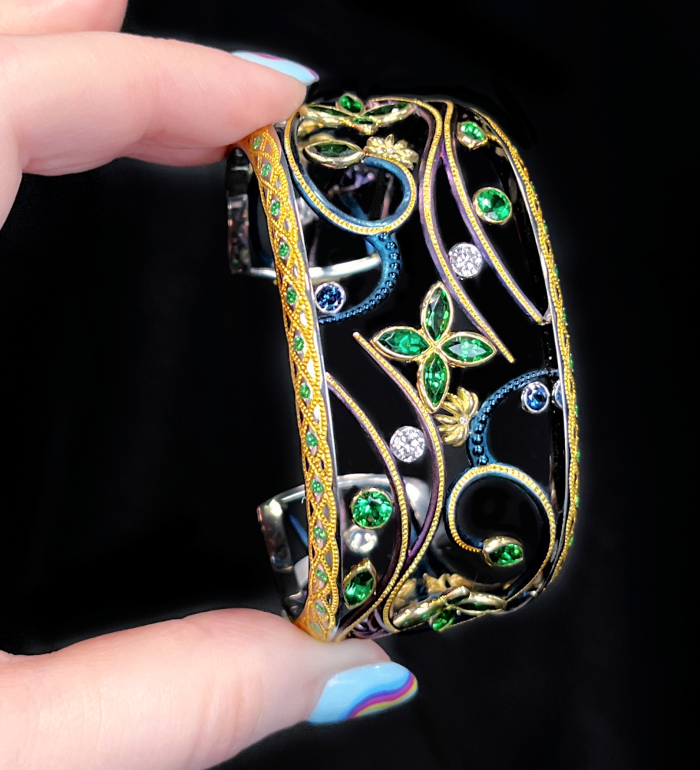 Colorful steel, platinum, and gold 'Into the Mystic' cuff bracelet by Zoltan David. With Tsavorite garnet, blue sapphires, and diamonds.