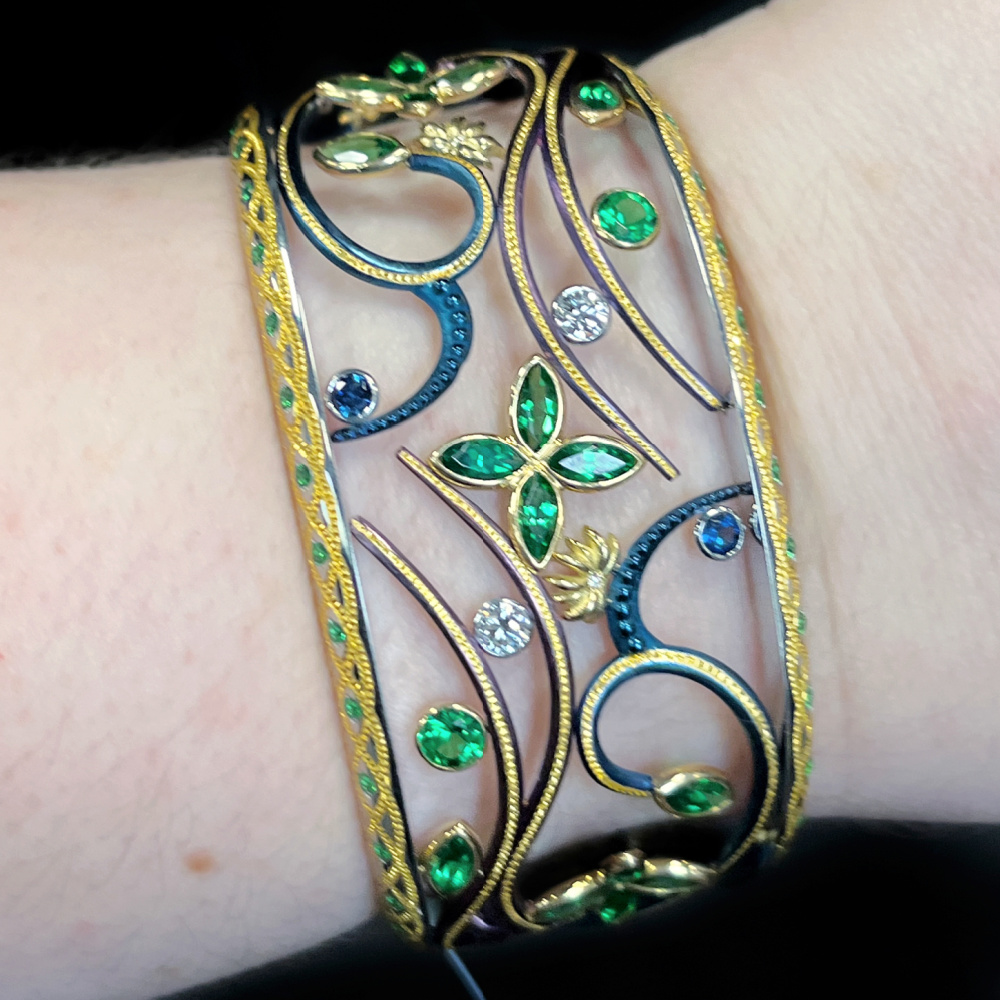 Colorful steel, platinum, and gold 'Into the Mystic' cuff bracelet by Zoltan David. With Tsavorite garnets, blue sapphires, and diamonds.